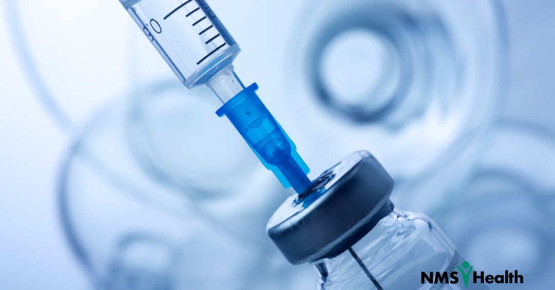 Needle extracting vaccine from vial