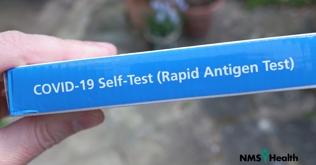 hand holding a COVID-19 rapid test